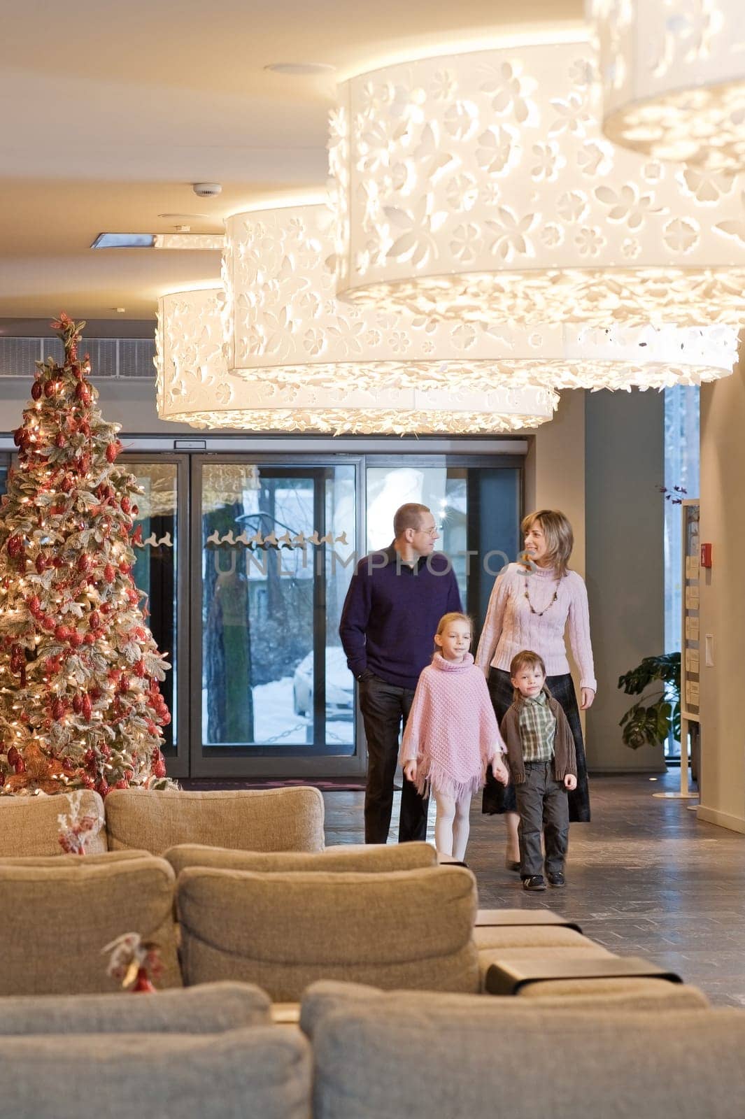 Happy family walking at foyer in the mod