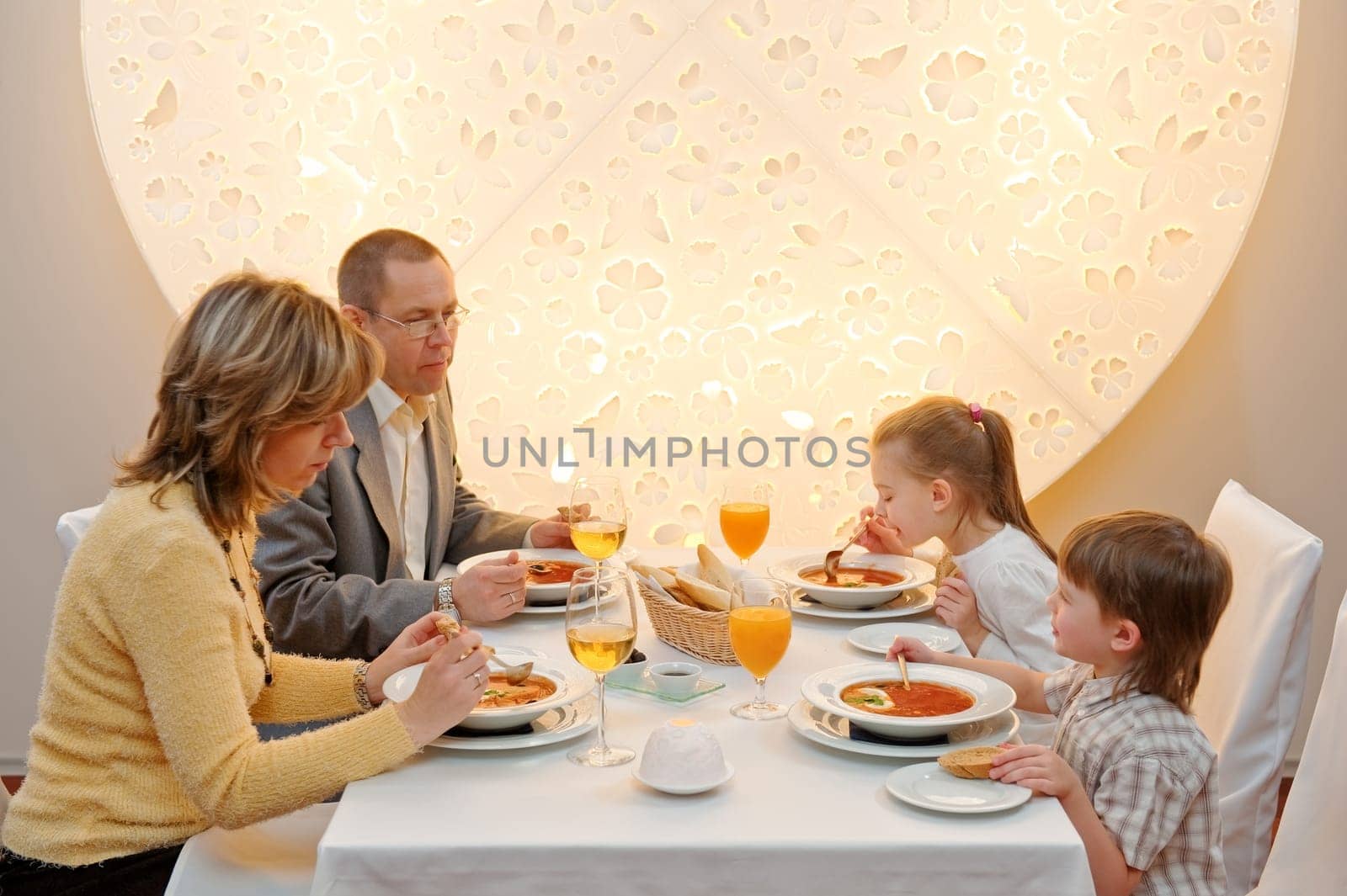 Happy family enjoying meal sitting at re