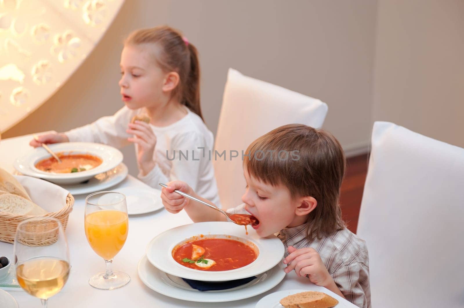 Sister and brother enjoying meal sitting