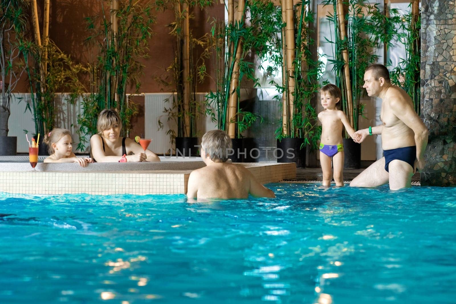 Happy attractive family relaxing by the