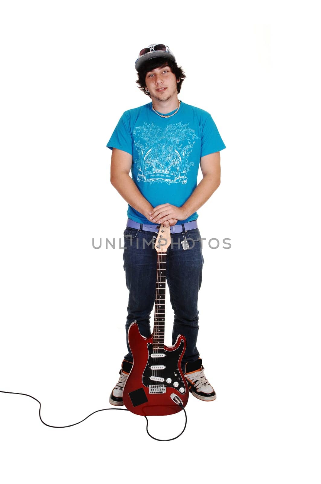 Boy standing with guitar.