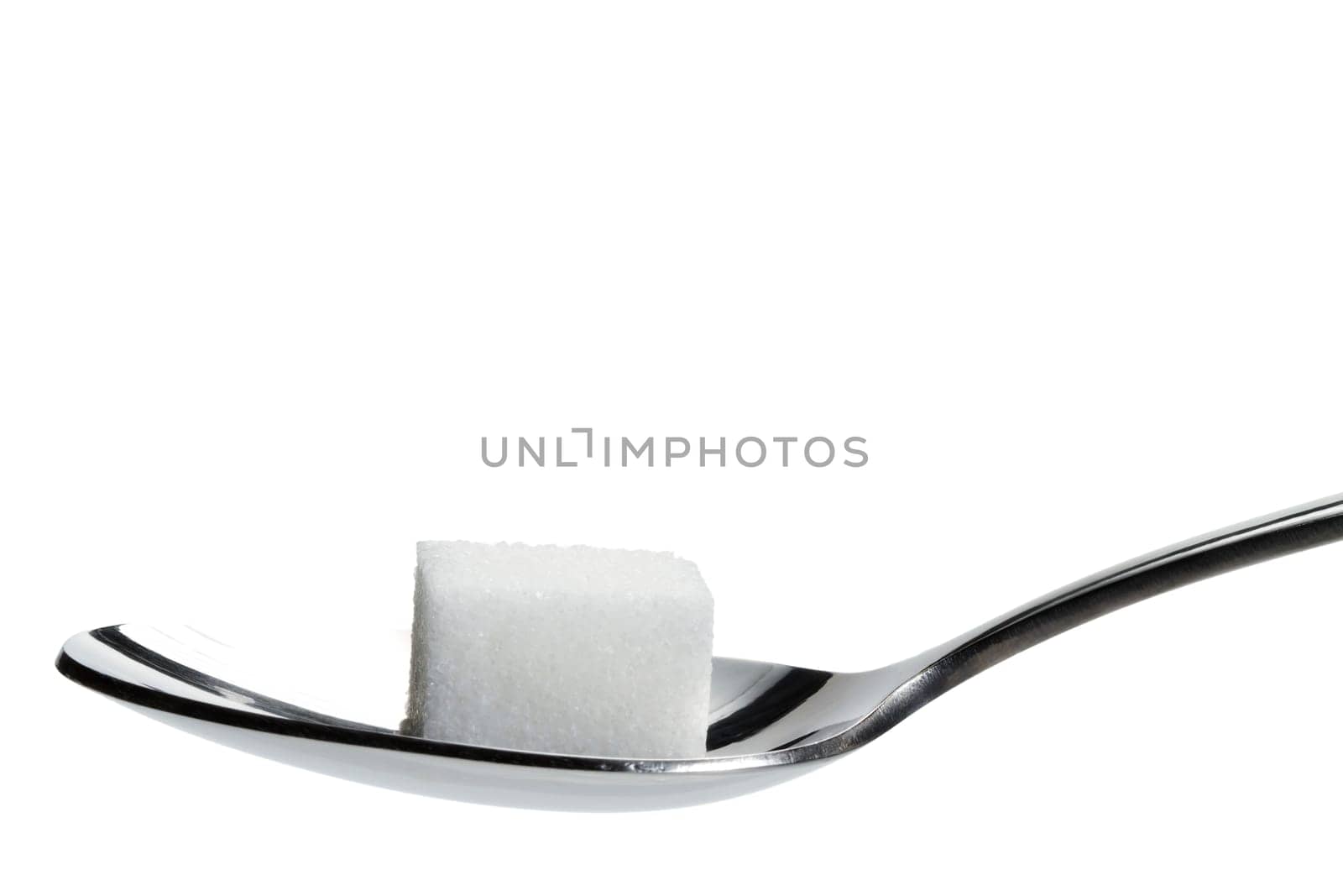 A sugar cube on a spoon