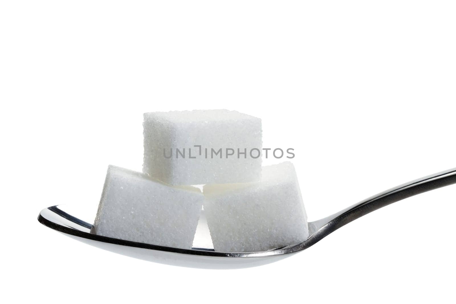 Three sugar cubes on a spoon