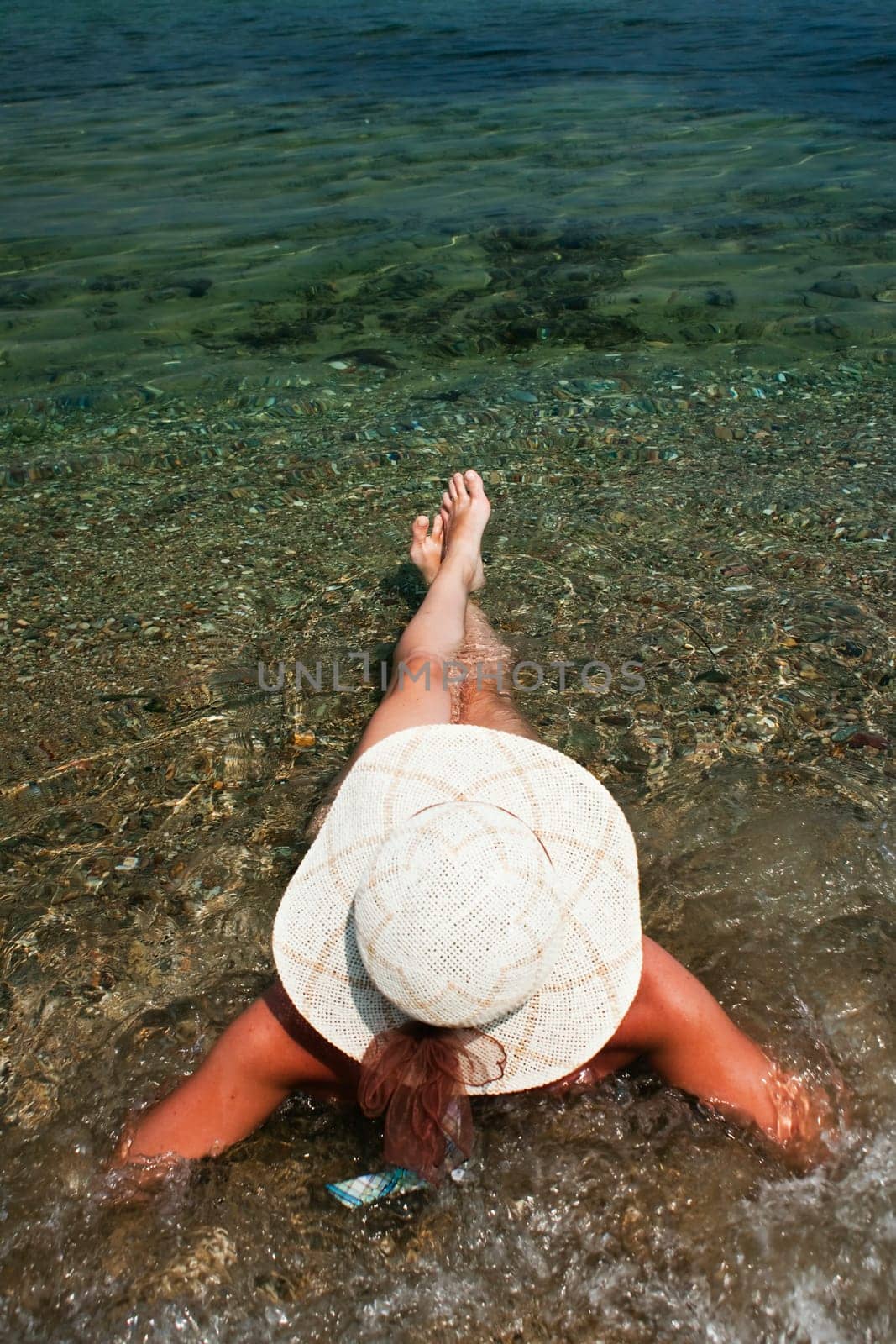 woman with hat on the beach