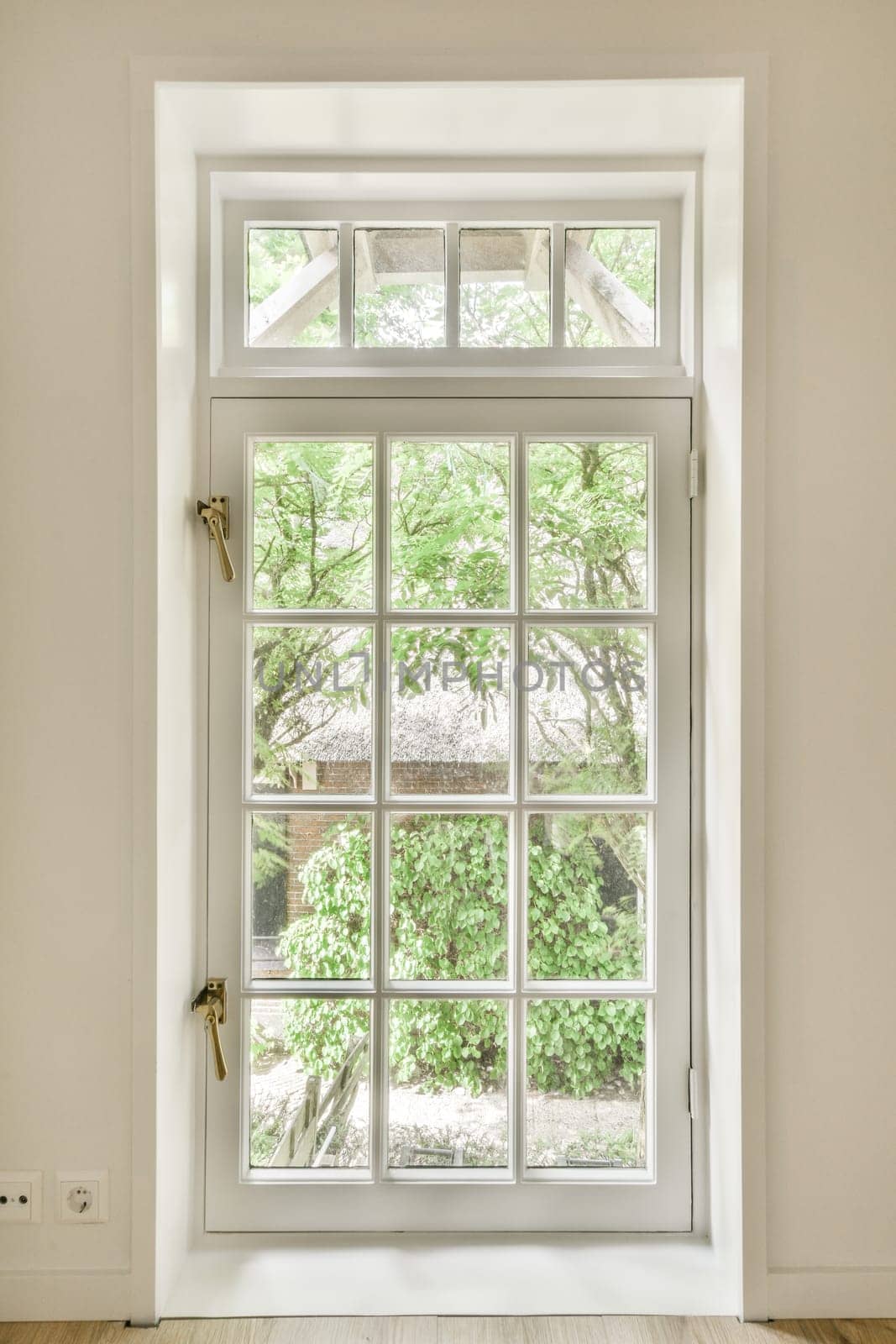 a white window with a view of a tree outside by casamedia