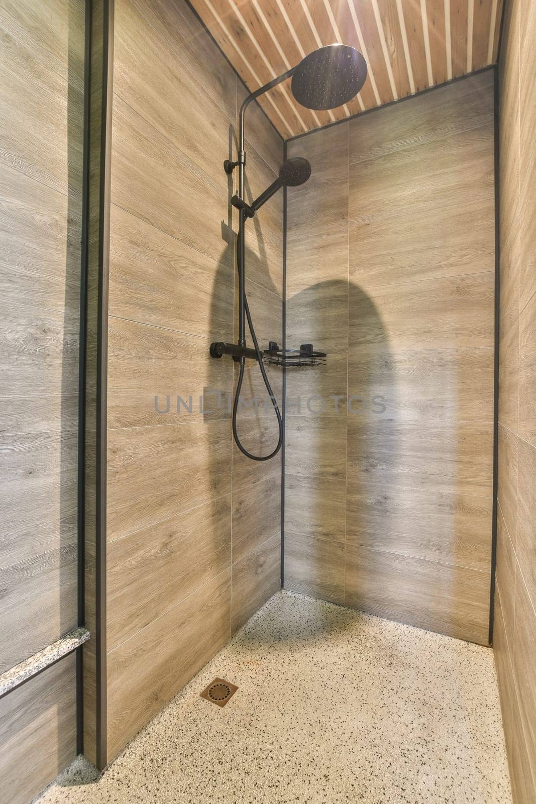 a walk in shower with wood walls and a shower by casamedia