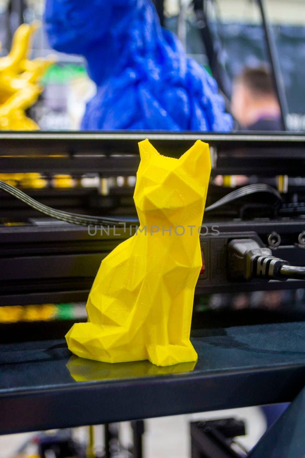Abstract models printed on 3D printer. 3D printer created object from molten plastic. Modern three-dimensional printing technologies. 3D printer and 3D printing. Innovation additive robotic technology