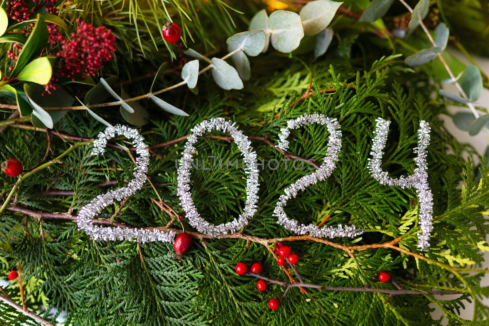 Christmas and New Year concept. The inscription 2024 on pine and fir branches. New Year 2024 idea concept