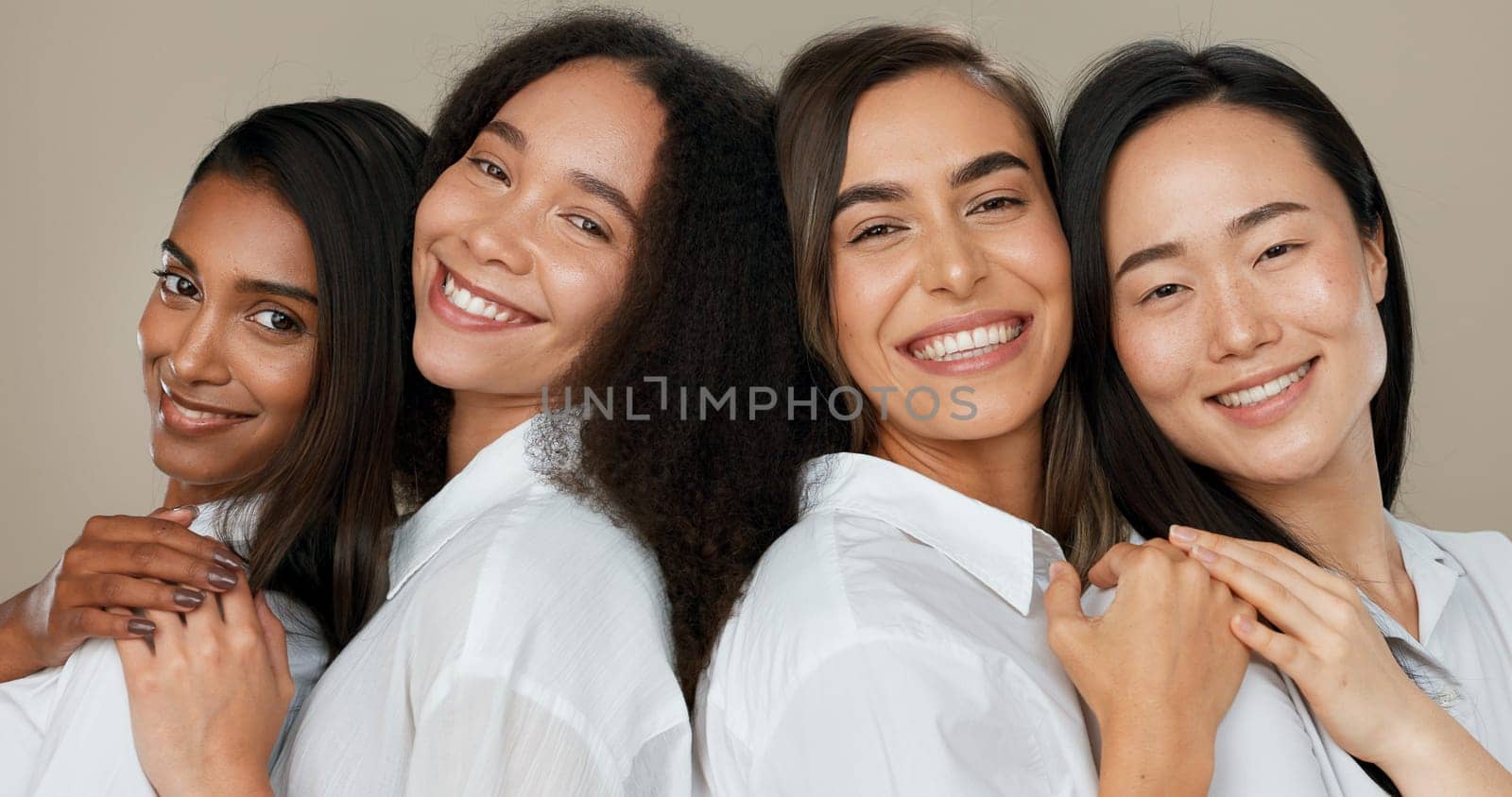 Women, group skincare and beauty with love, hug and support in diversity and inclusion on brown studio background. Friends, model or people smile together and kiss in dermatology, skin care or makeup by YuriArcurs