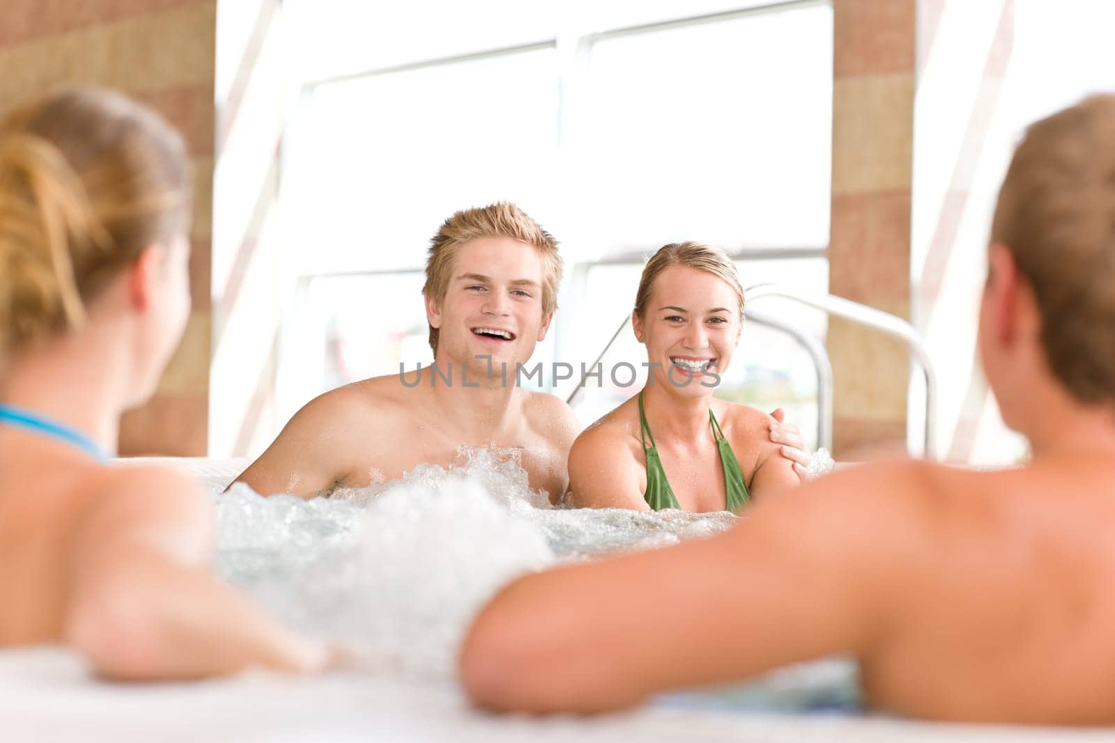Swimming pool - young couple relax in hot tub
