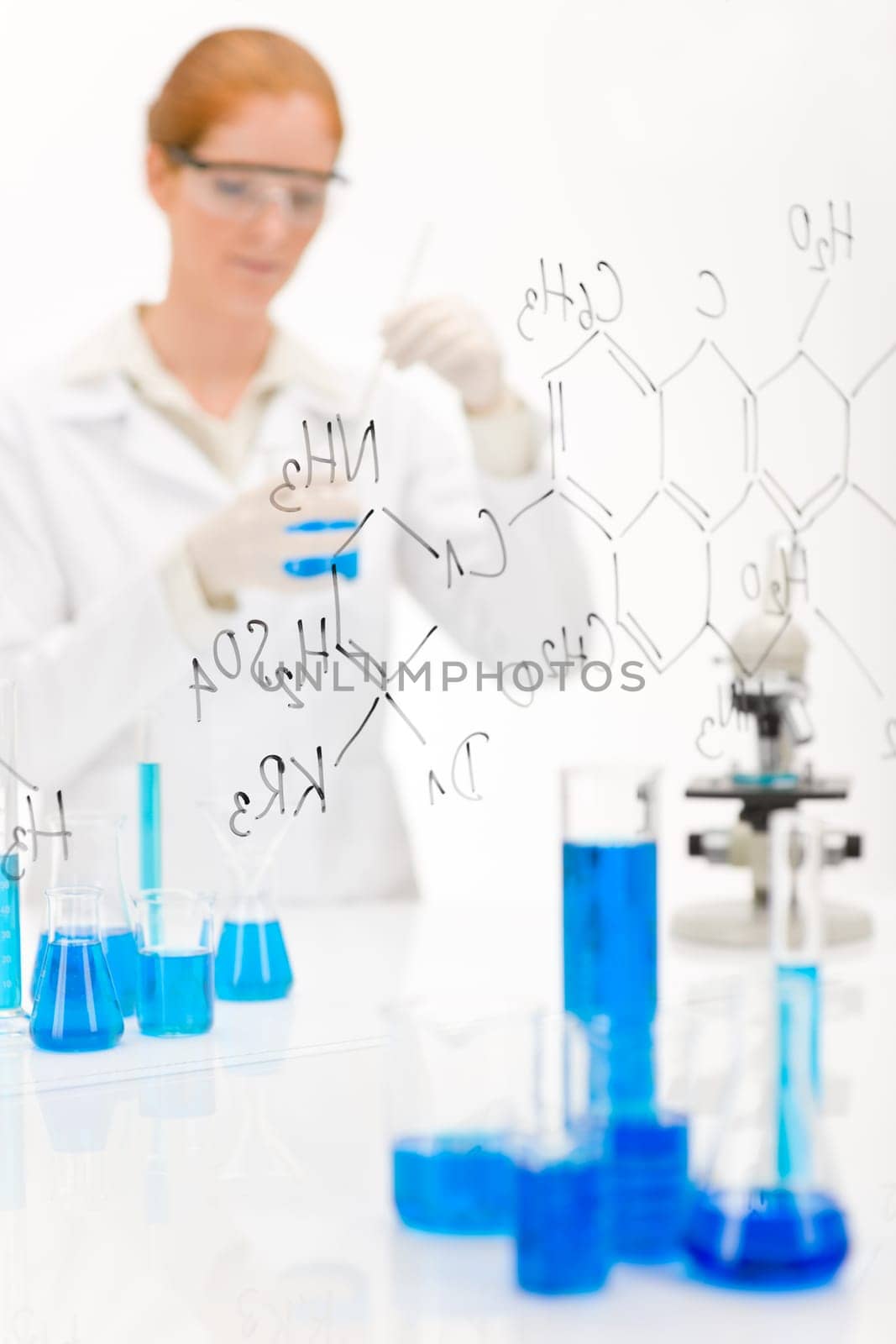 Woman scientist in laboratory chemical formula