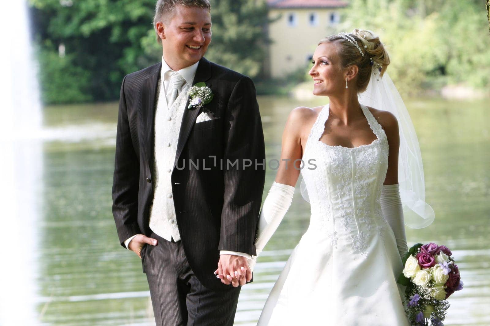Portrait - young newlyweds - hand in hand