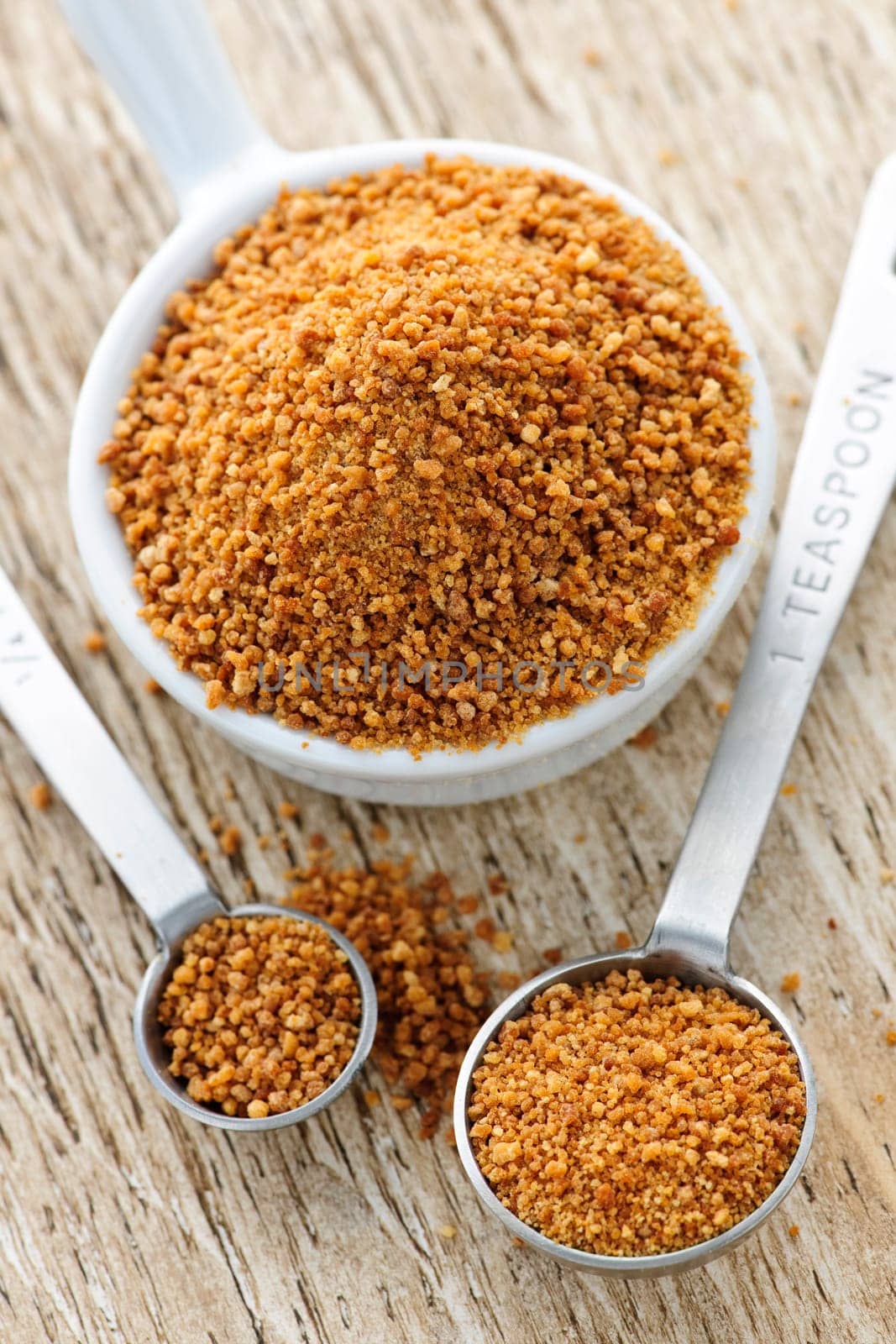 Coconut palm sugar in measuring spoons