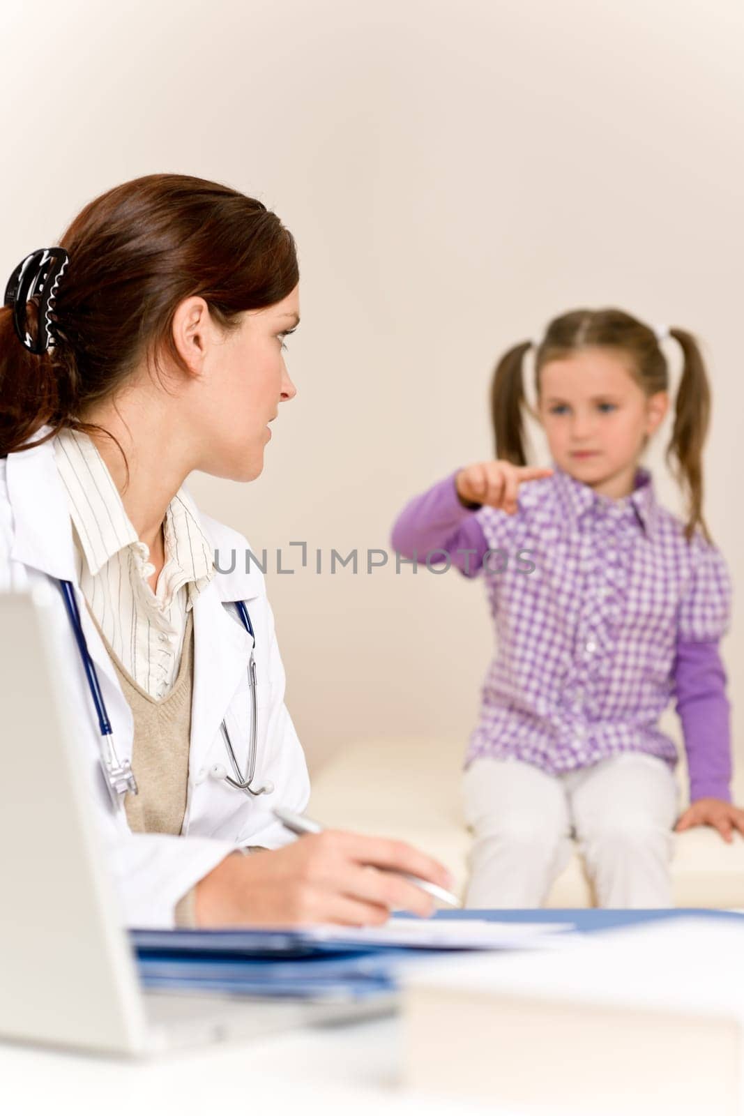 Female doctor write prescription for child