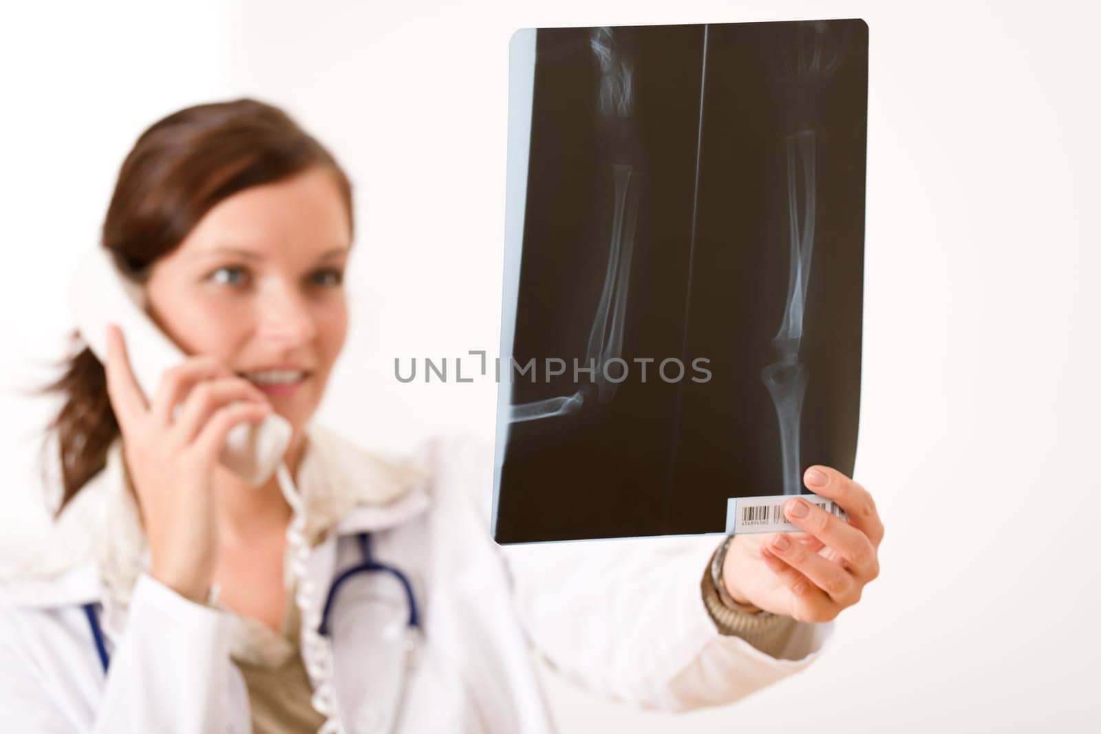 Female doctor with x-ray and phone