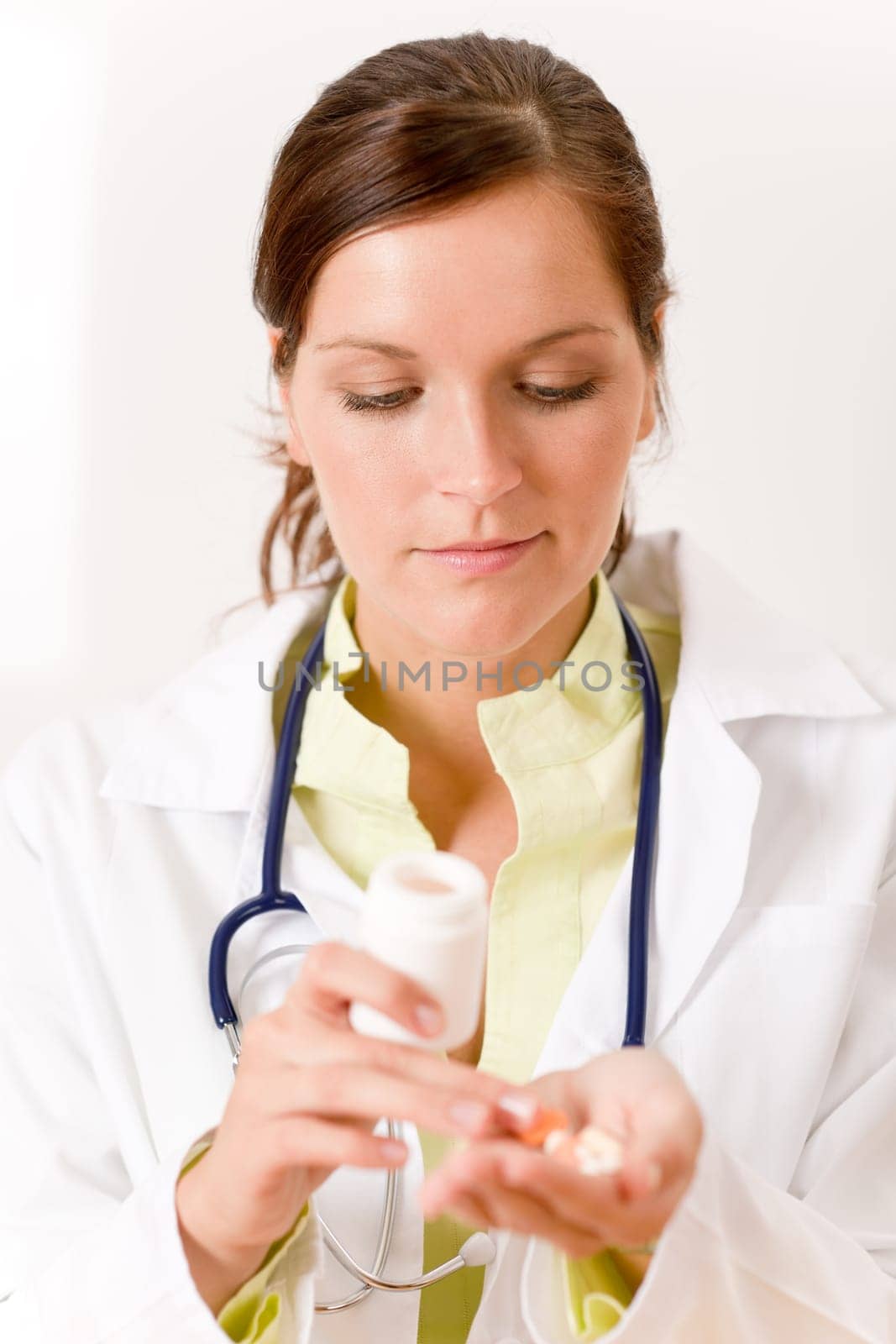 Female doctor with stetoscope holding tablet