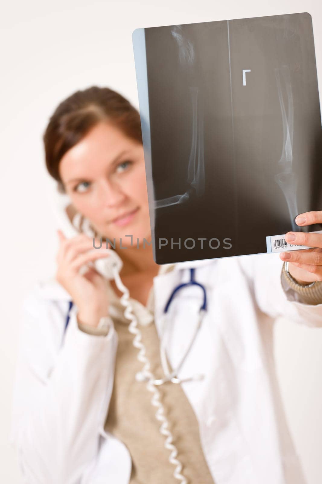 Female doctor with x-ray and phone