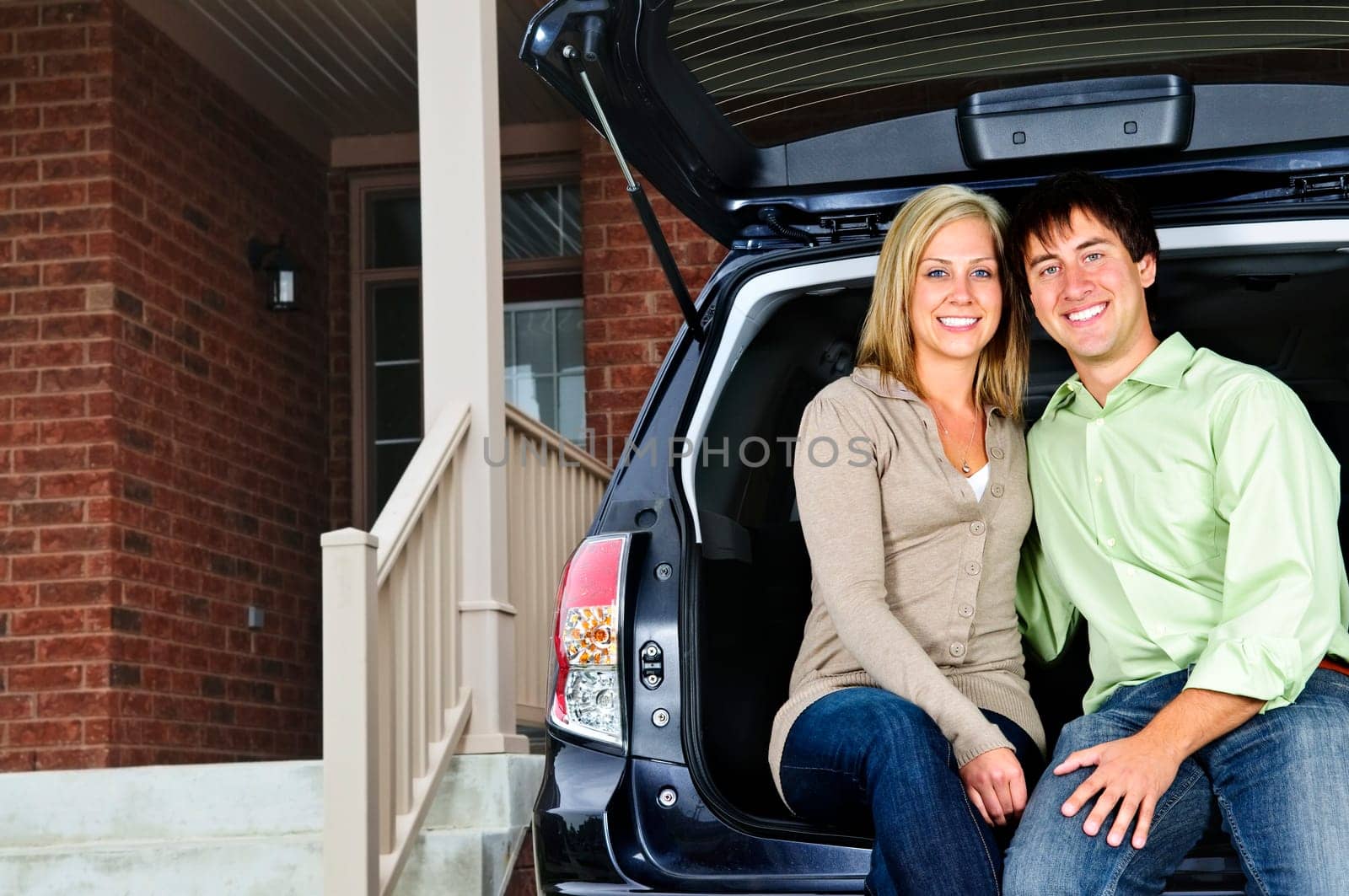 Couple sitting in back of car