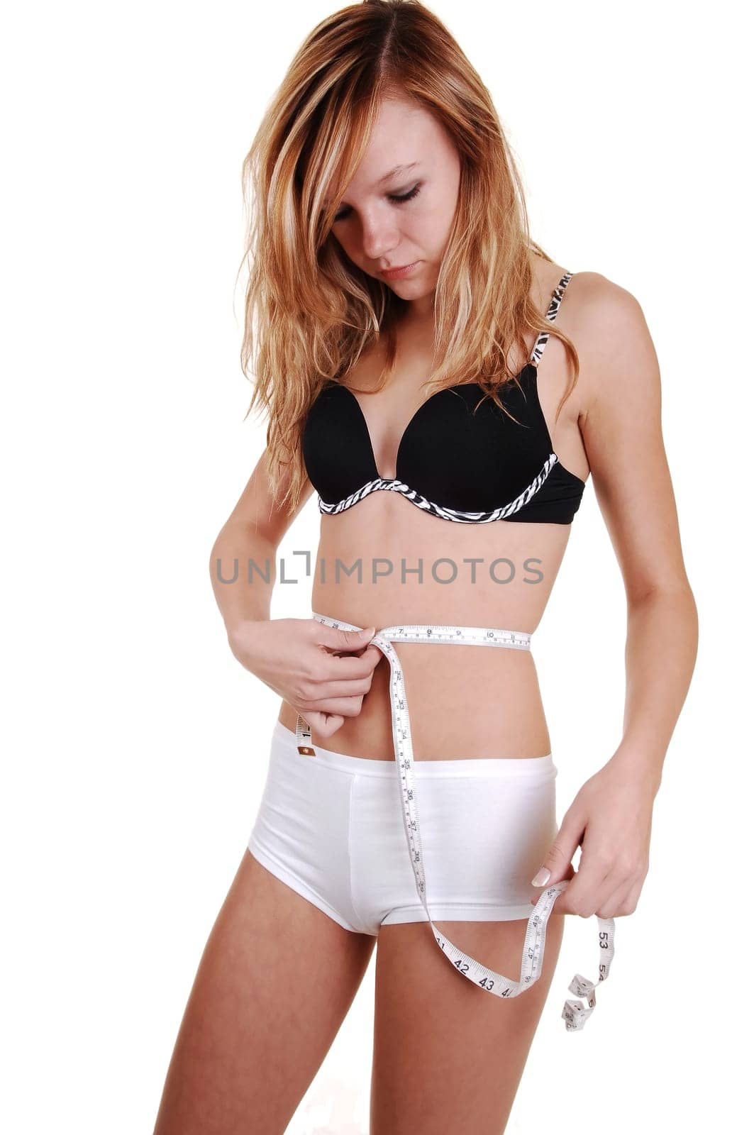 Girl measuring her belly.