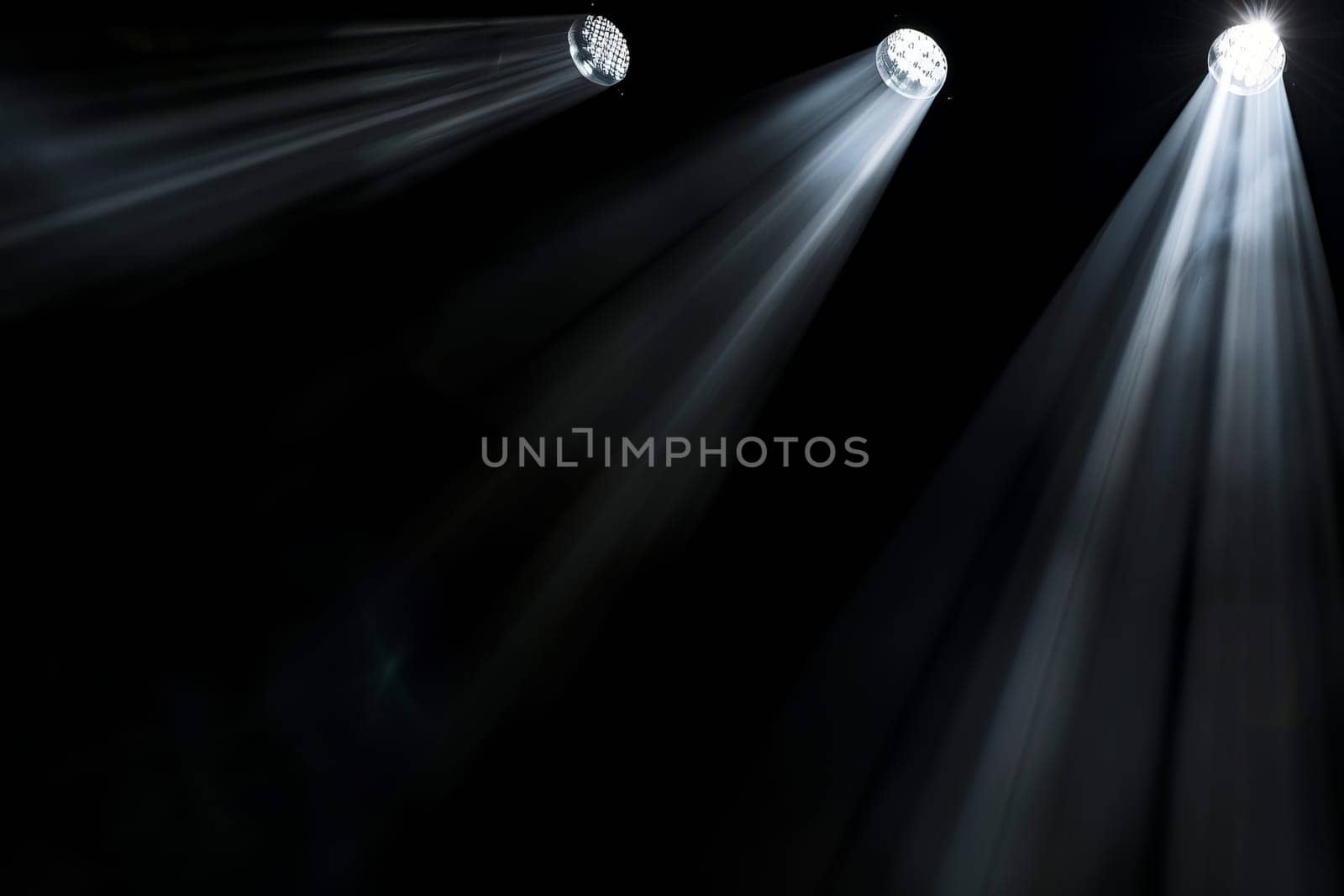 Dramatic stage spotlight illumination with three beams in dark setting.