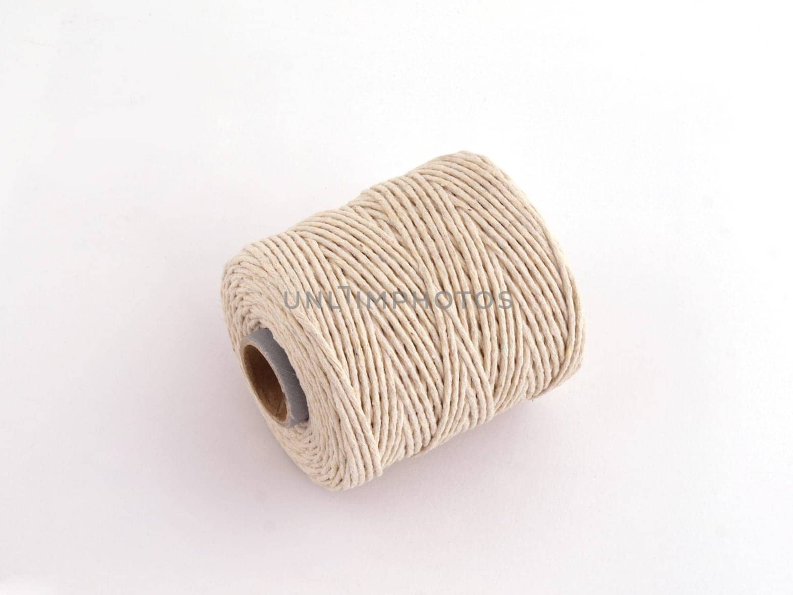 Ball of string or twine on a plain white background.