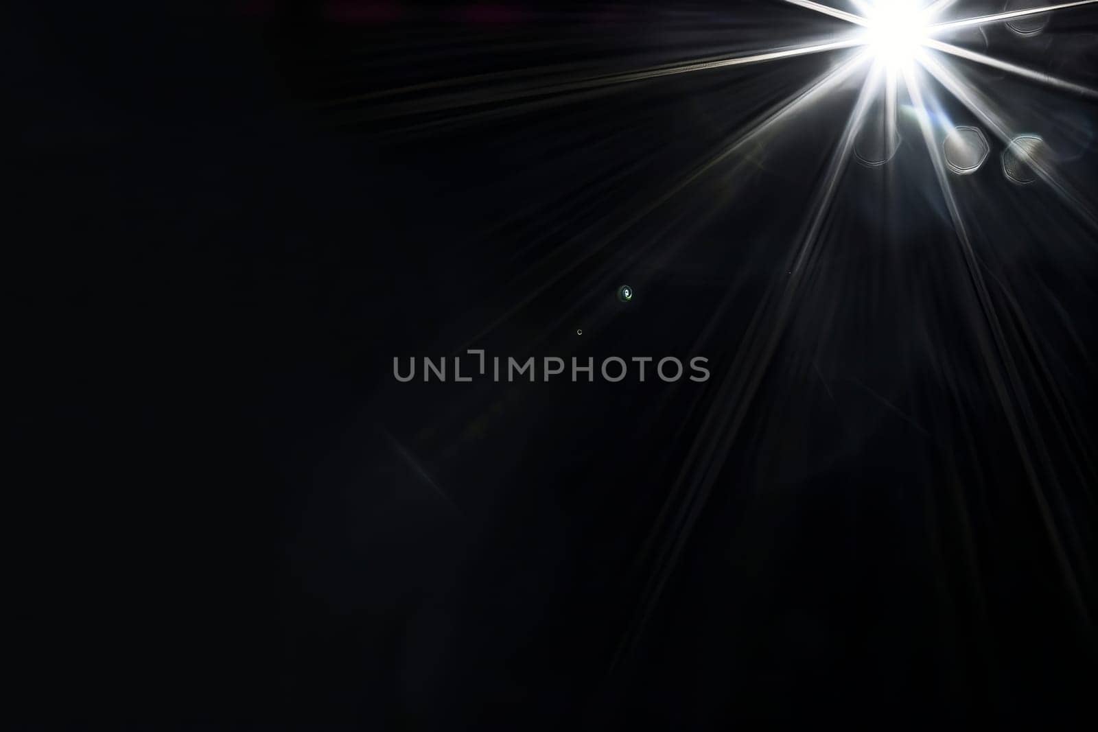 Bright light burst with starburst effect on dark background.