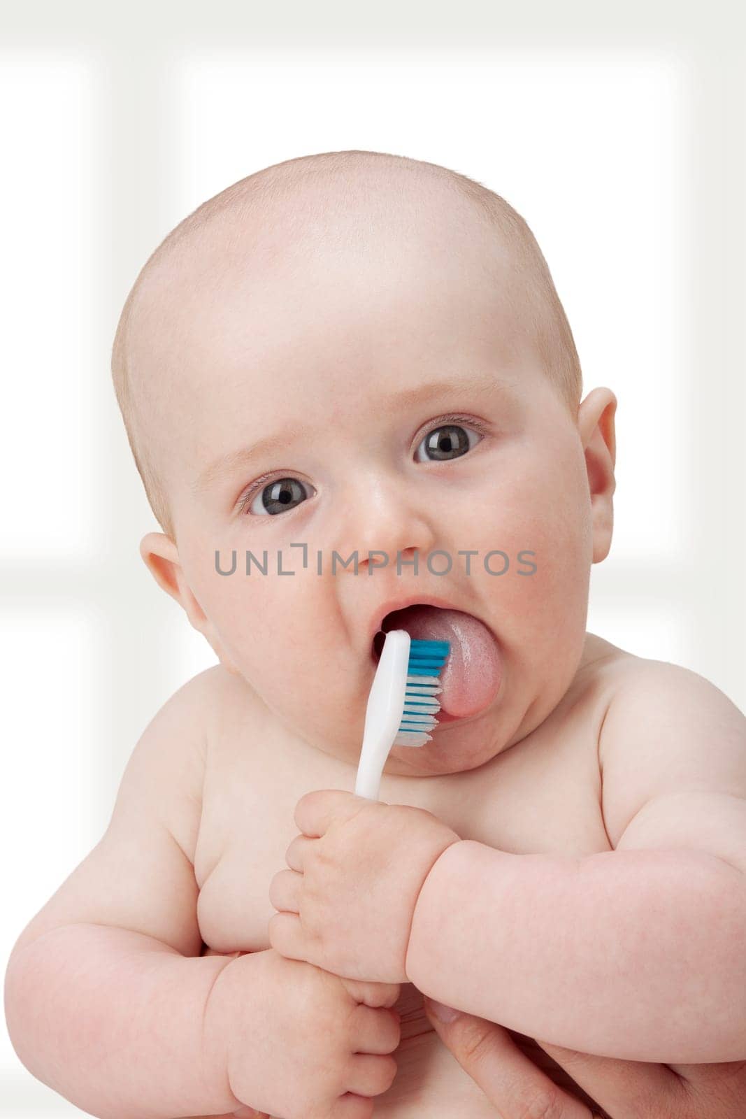 Baby boy playing with a new toothbrush