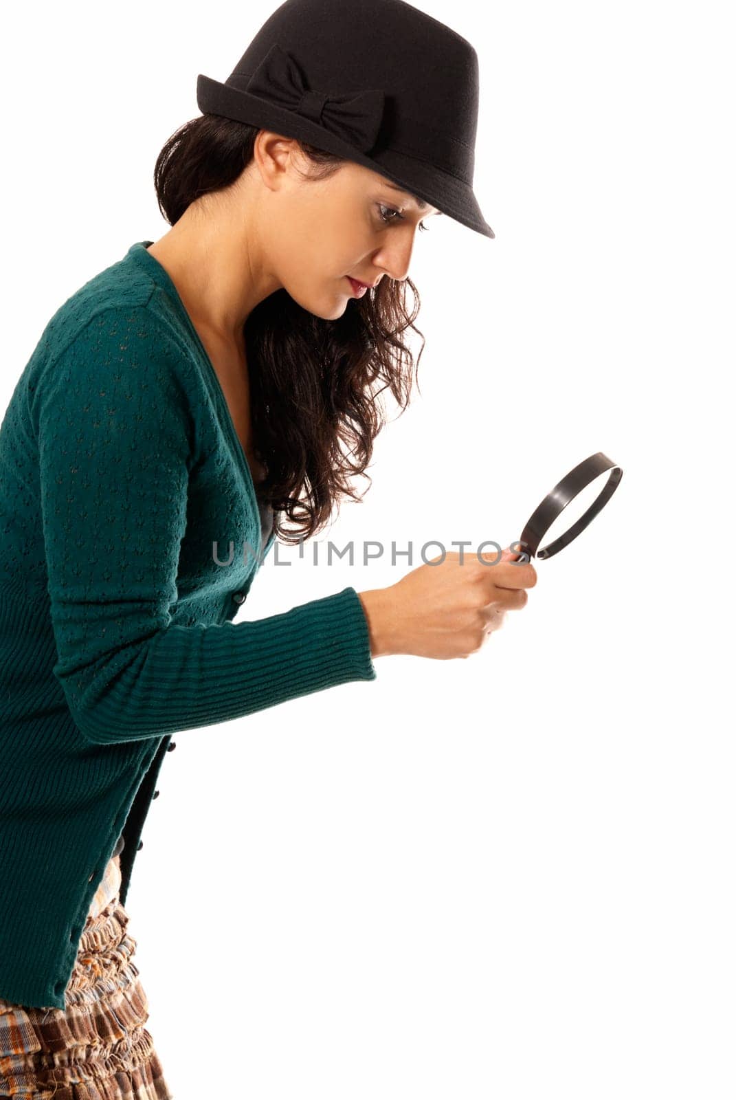 young woman with magnifier glass and hat looking for something isolated on white