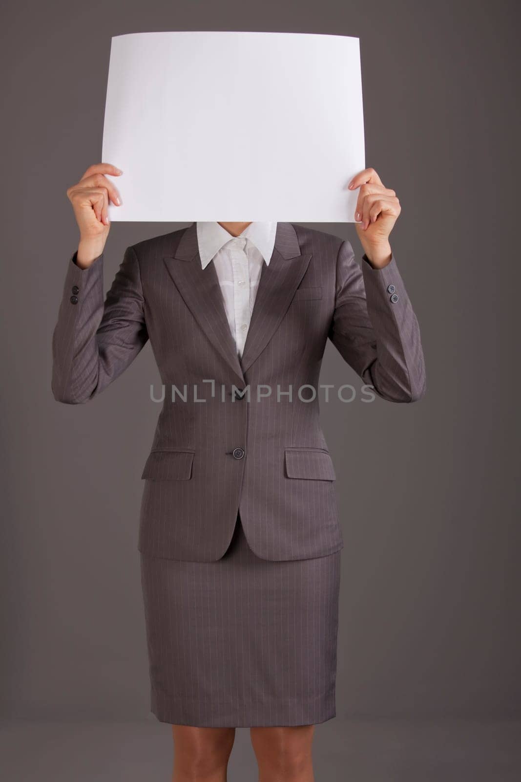 woman holding blank paper over face