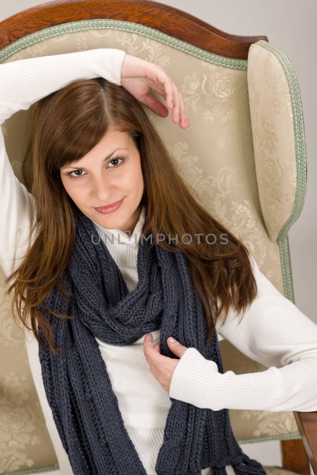Fashion model posing on antique armchair