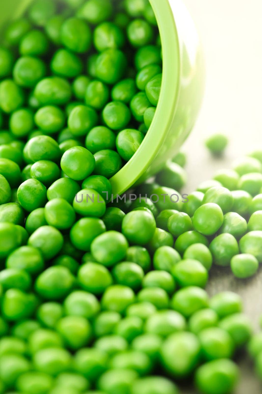 Spilled bowl of green peas
