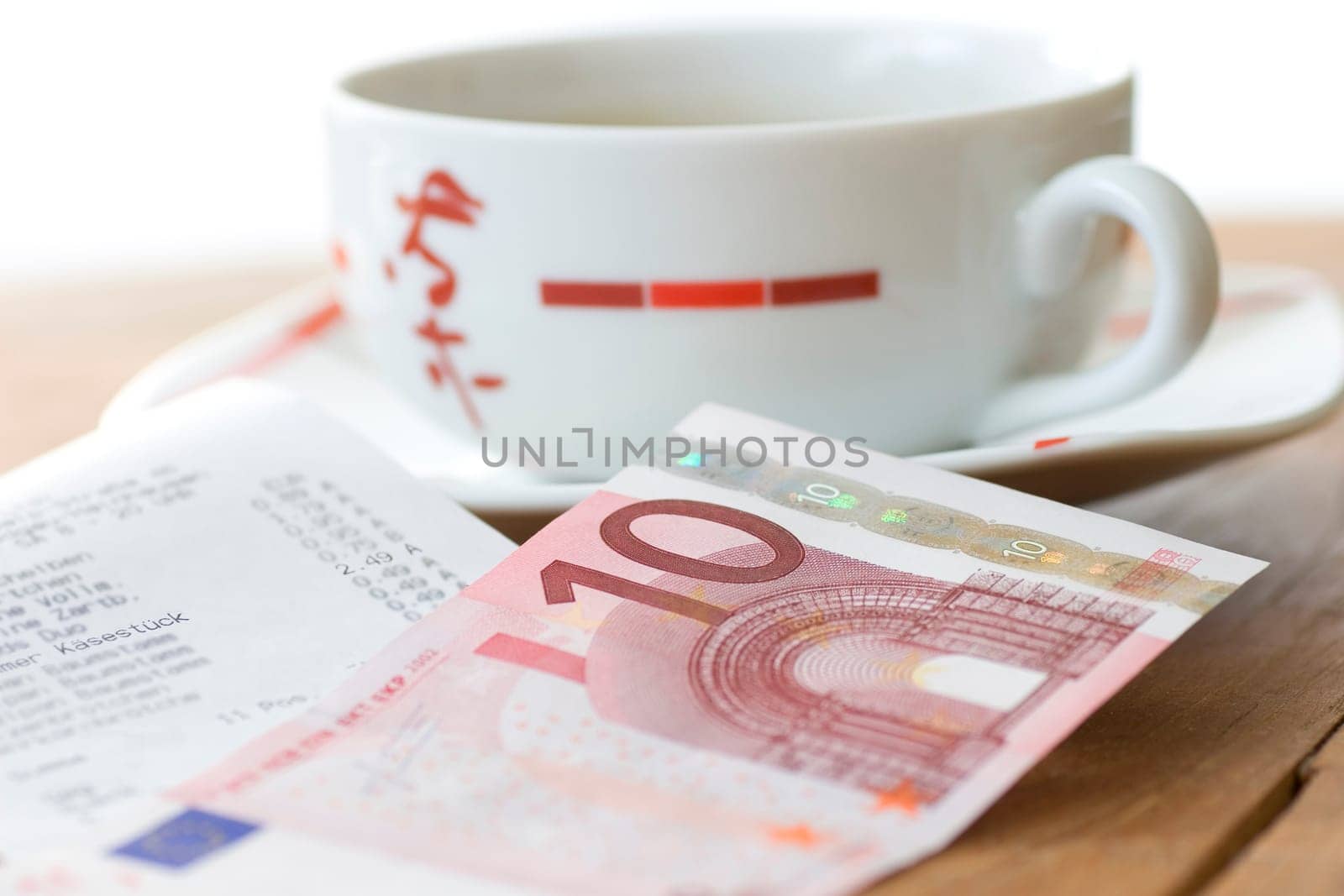 Teacup with receipt and banknote (no pr)