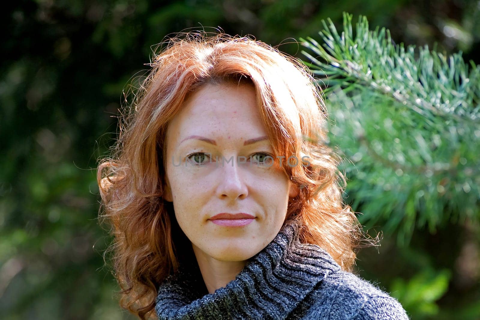 Portrait of red-haired adult woman in na