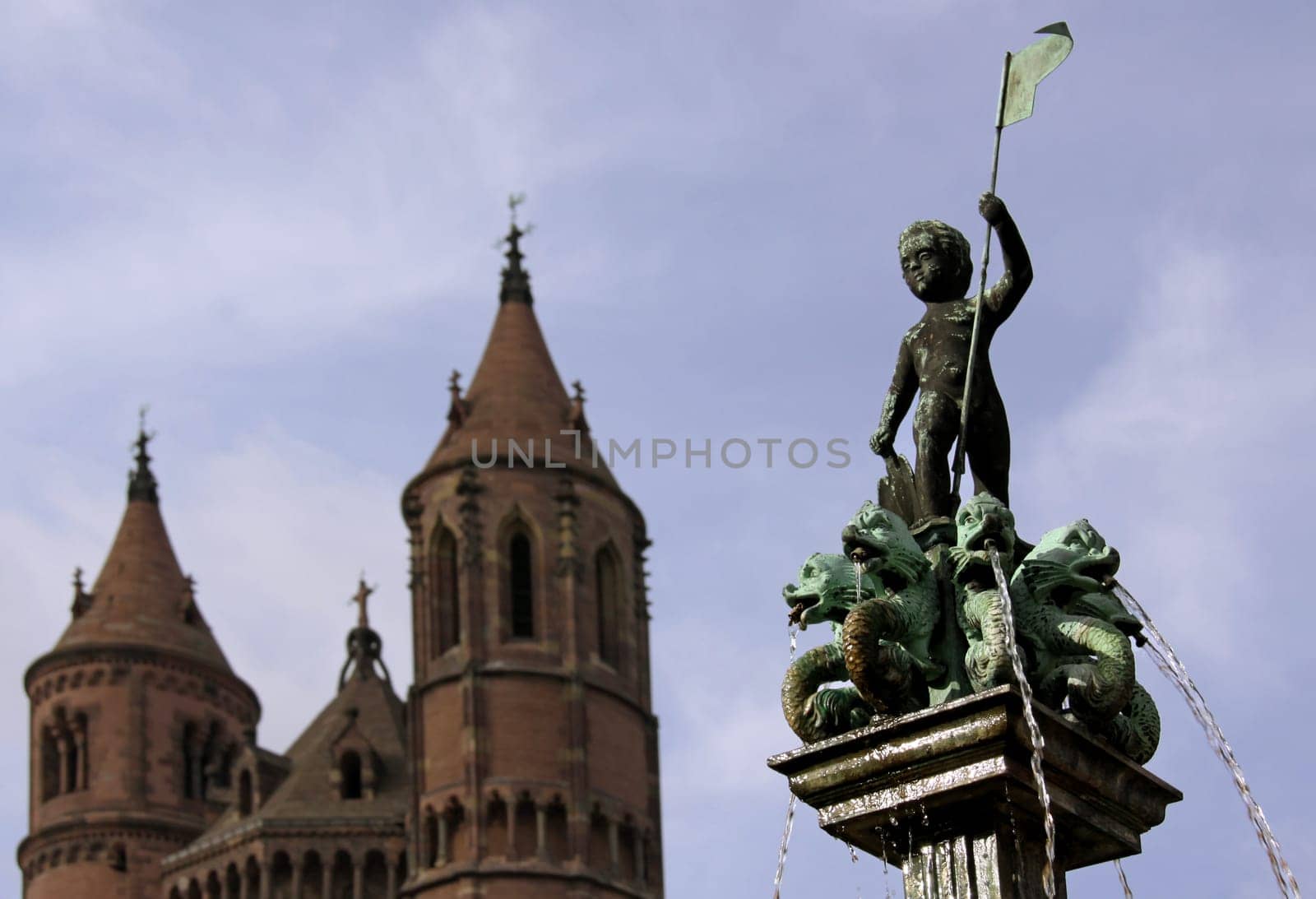 Fountain figure on the Schlossplatz in Worms with St. Peter's Cathedral (towers of the west choir) in the background