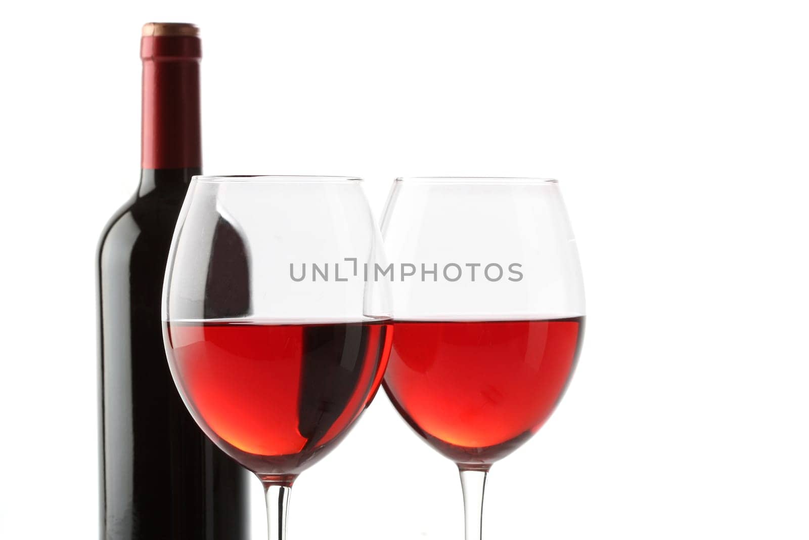 Two glasses of red wine and a bottle