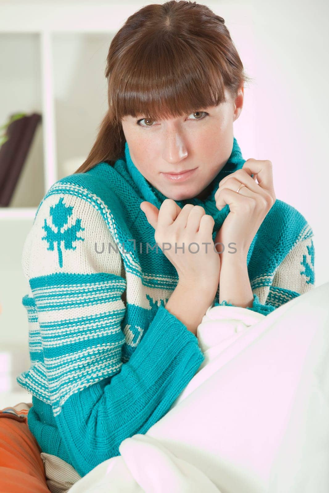 sad woman in sweater at home