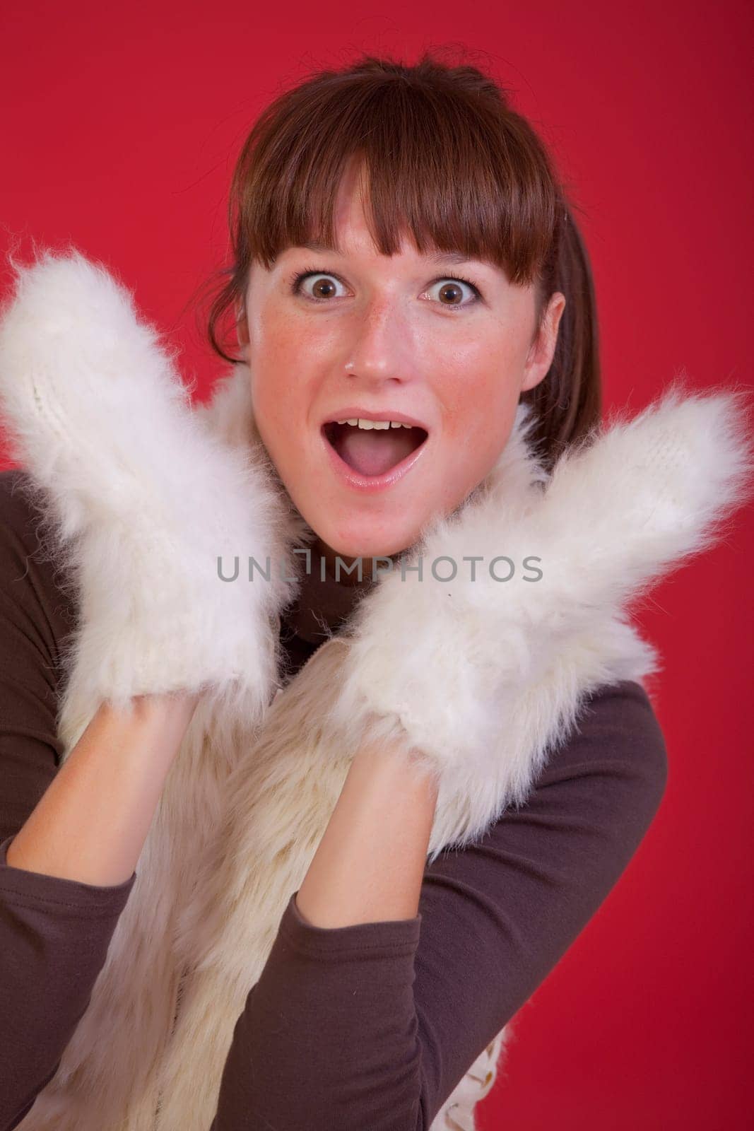 surprised woman in winter gloves