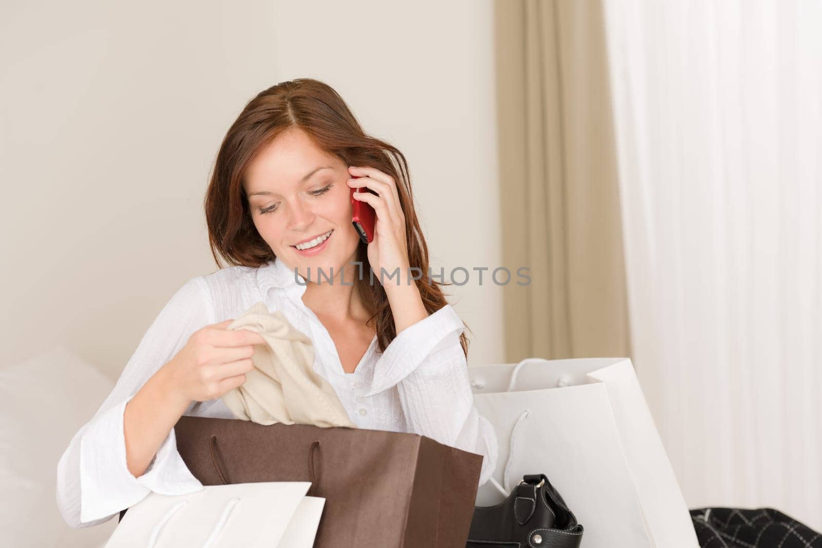 Woman on phone - back home from shopping