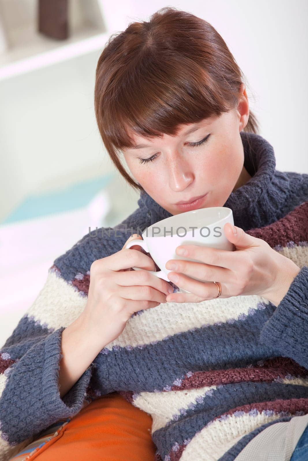 woman drinking tea on sofa