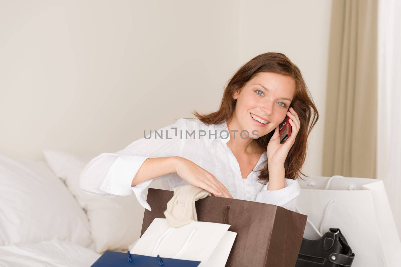 Woman on phone - back home from shopping