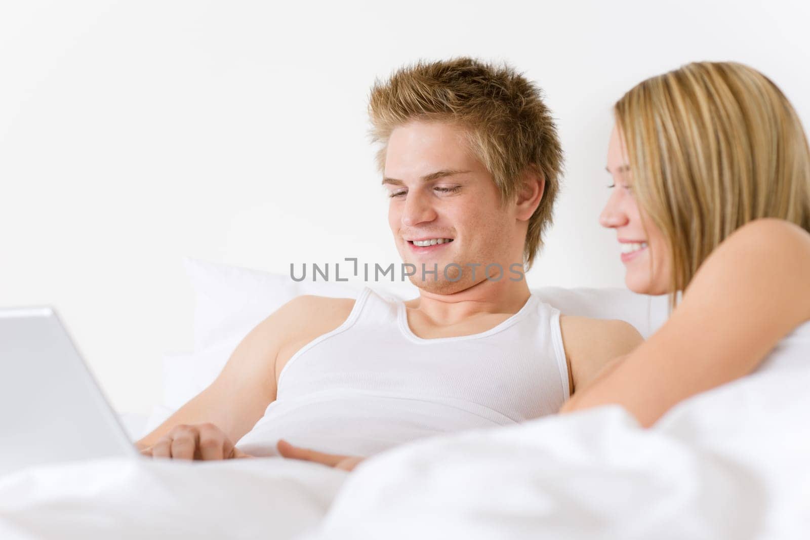 Bedroom - young couple with laptop