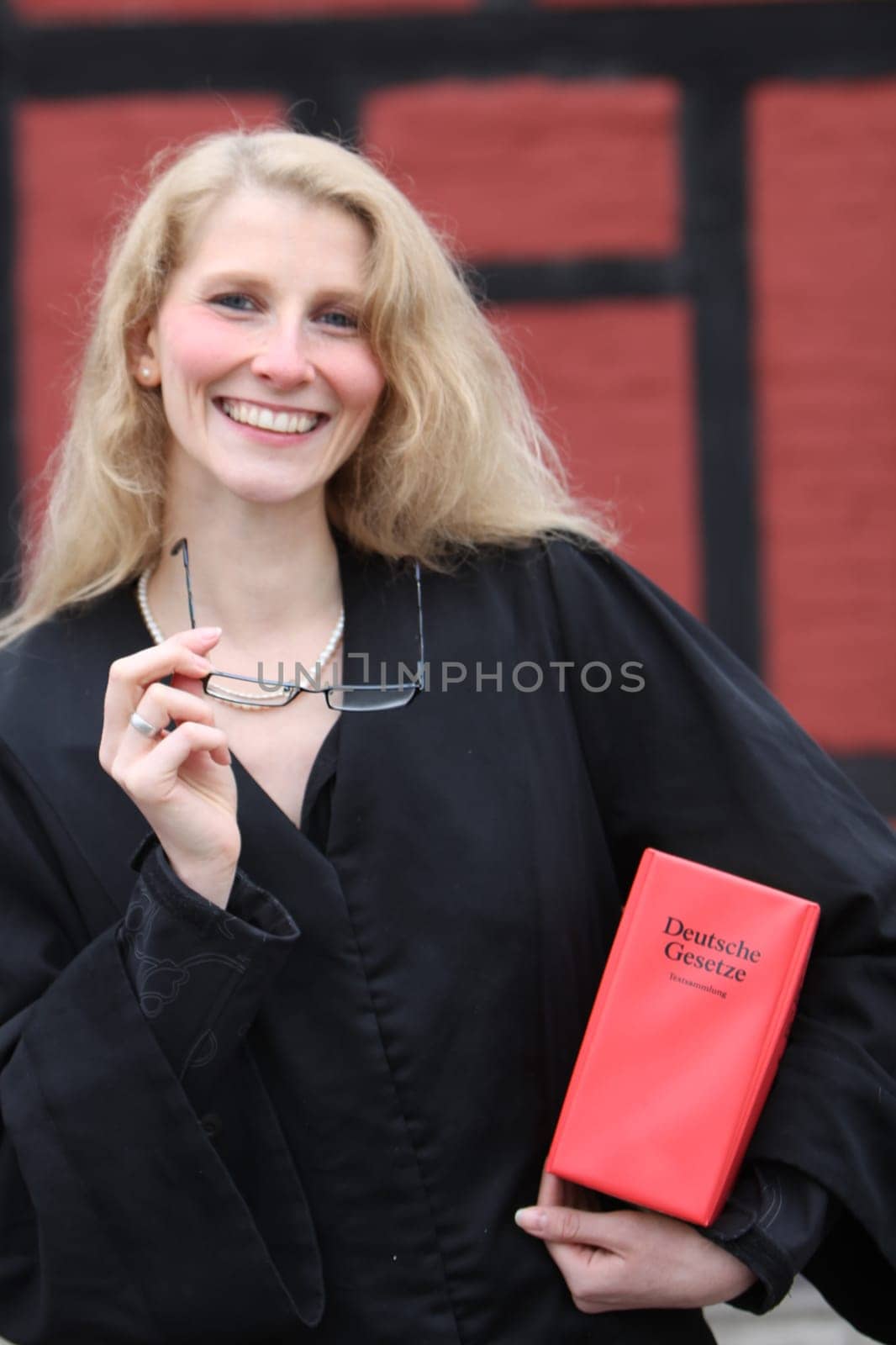 Law student or lawyer with red code under her arm