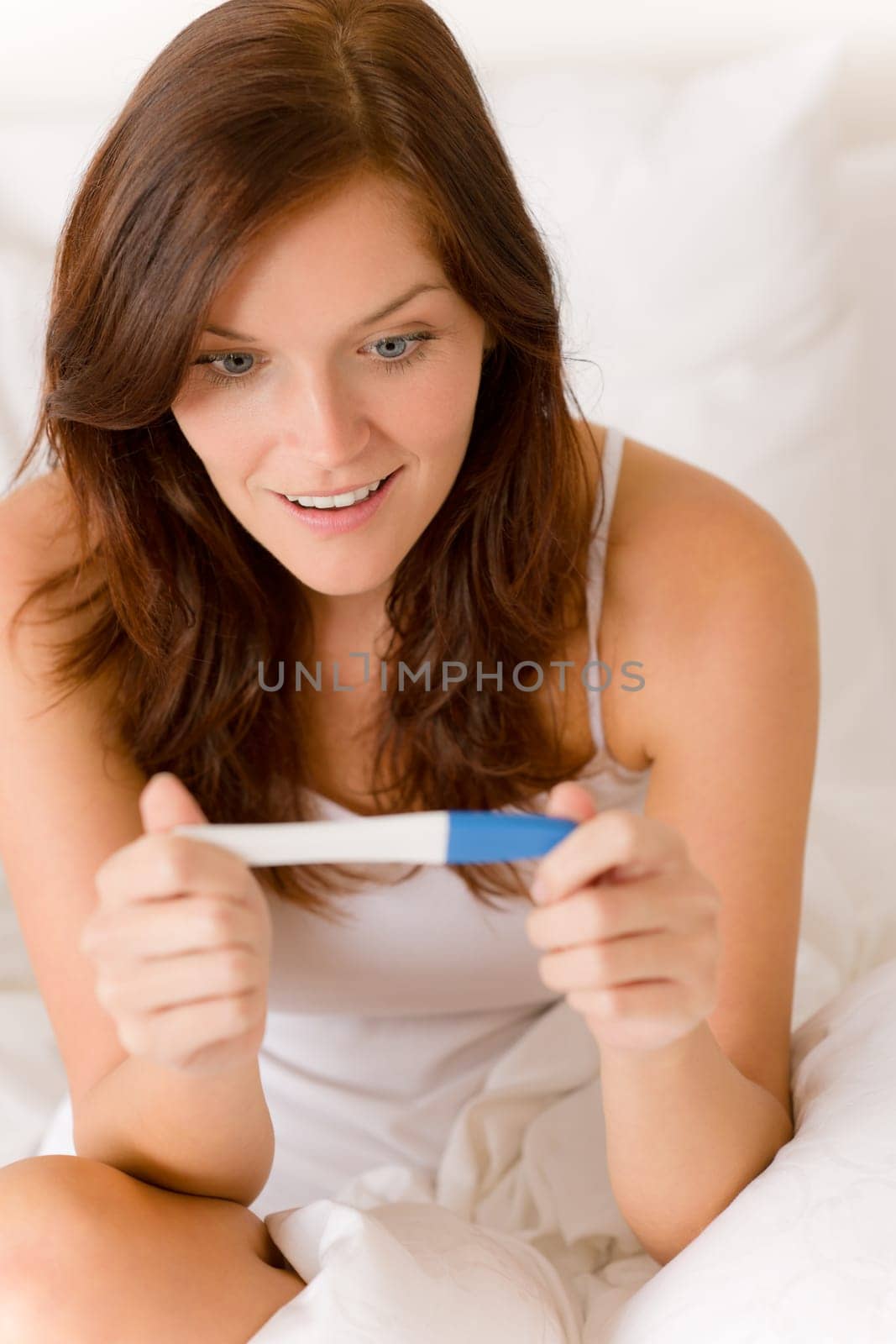 Pregnancy test - happy surprised woman