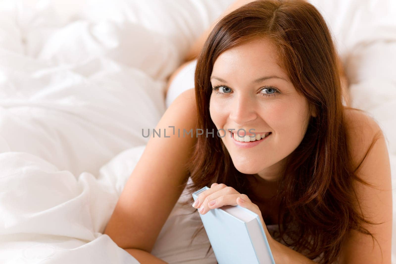 Bedroom - young happy woman with book