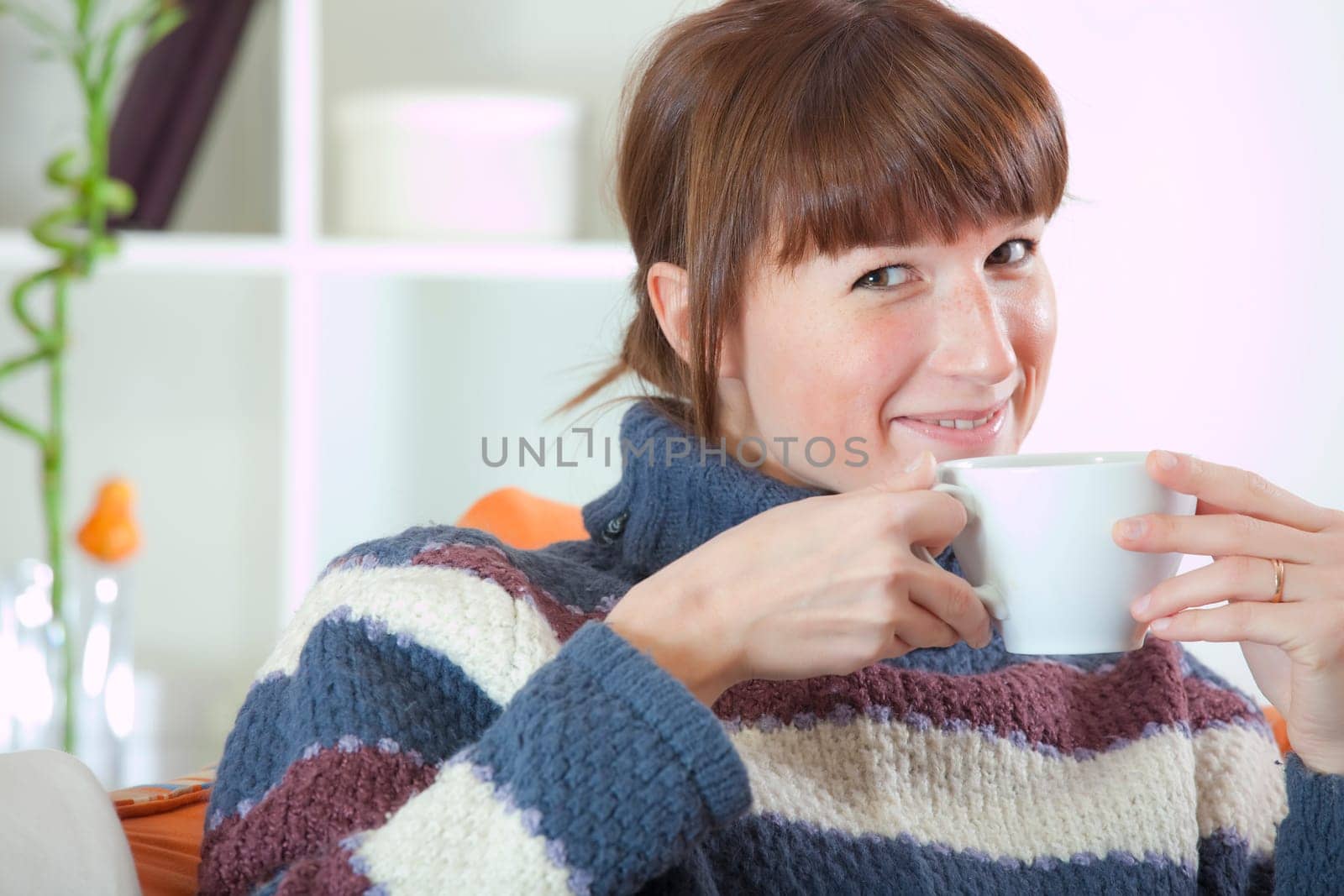 woman on sofa drinking tea