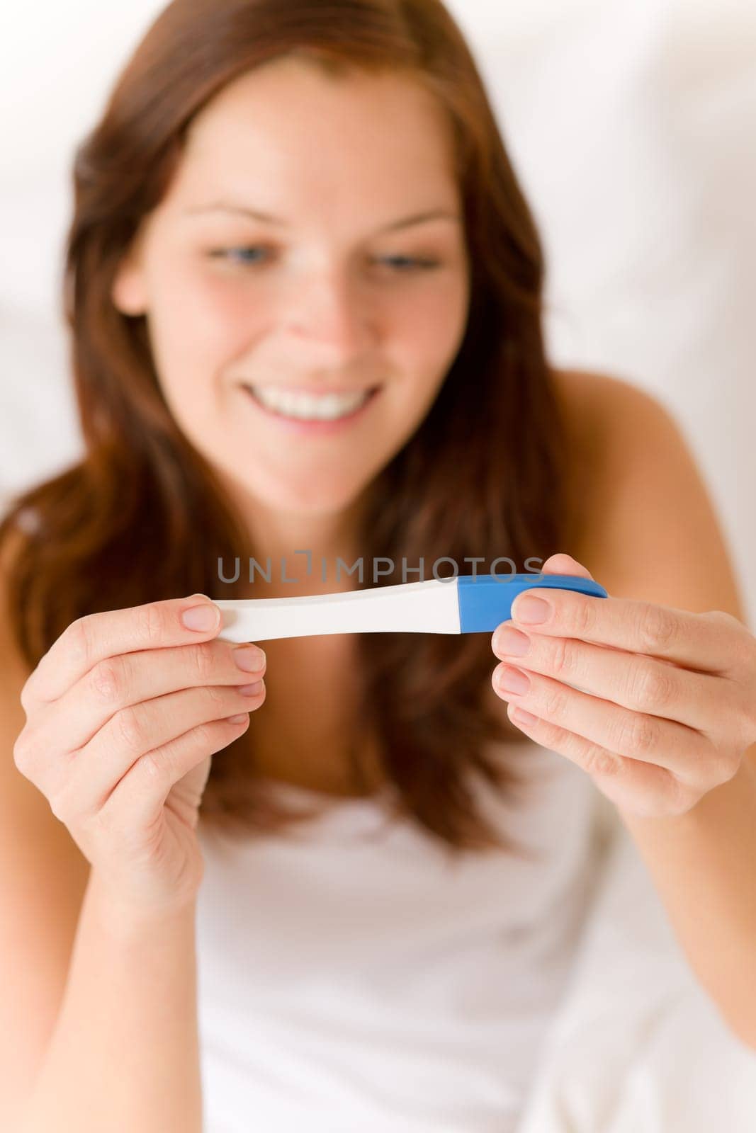 Pregnancy test - happy surprised woman