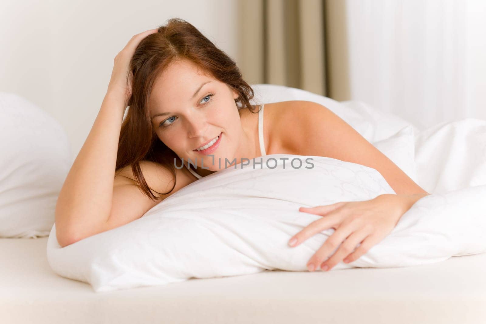 Bedroom - happy woman in white bed