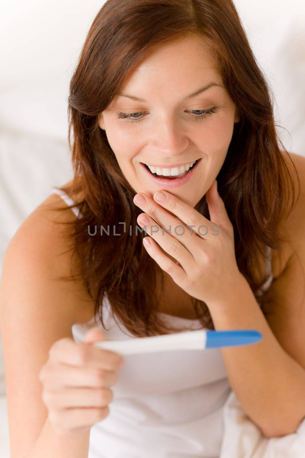 Pregnancy test - happy surprised woman