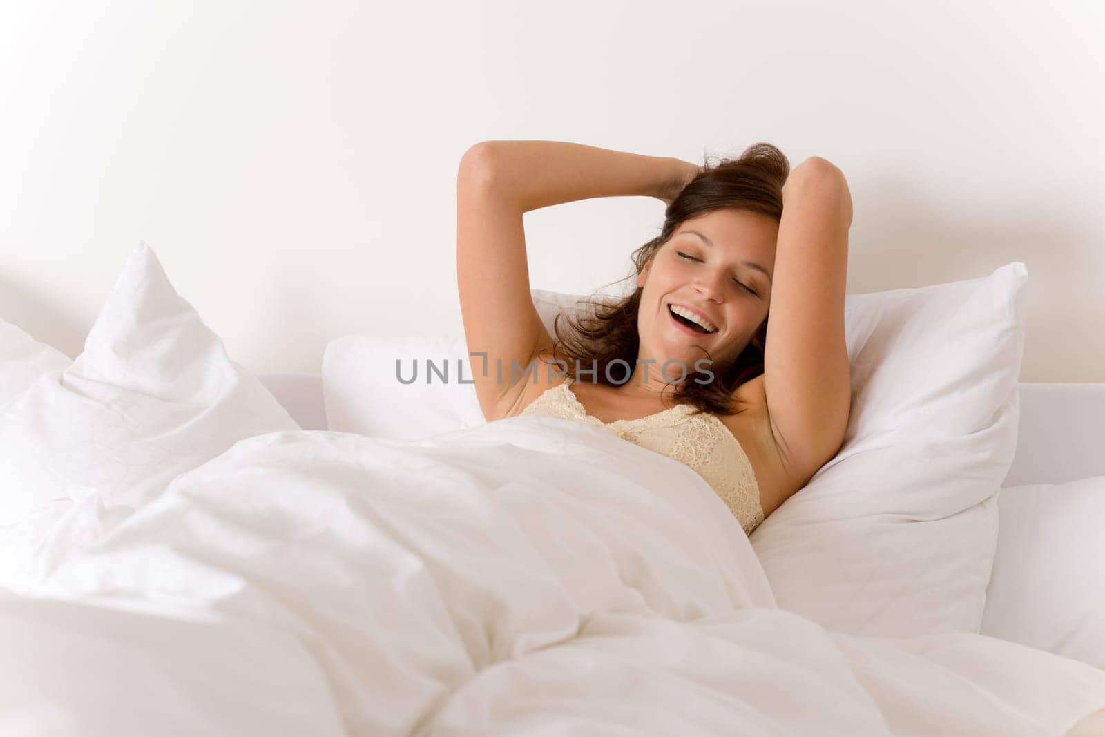 Bedroom - woman waking up and stretching