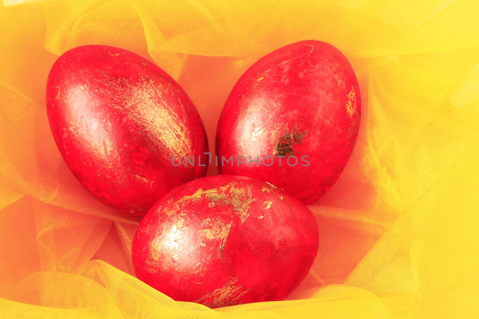 three red and gold Easter eggs